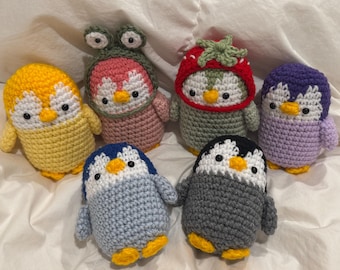 Crochet Penguin Plushie wearing (Frog and Strawberry) Hat