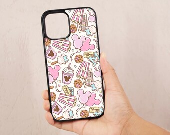 May include: A white phone case with a black border. The case features a pink and white pattern of Mickey Mouse ears, popcorn, balloons, and other Disney-themed imagery. The text "Magic" appears on the case.