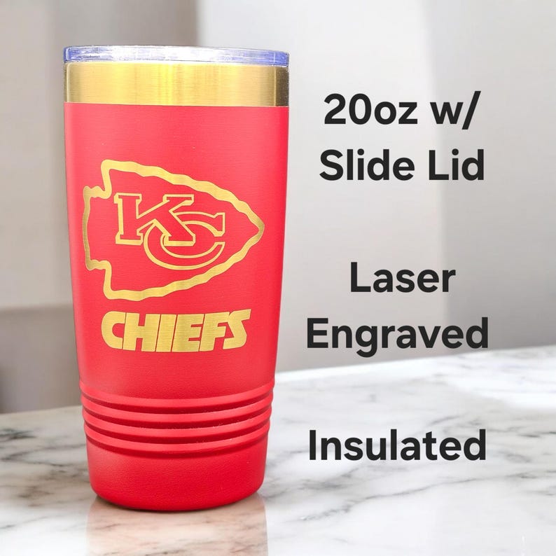 May include: A red 20oz insulated tumbler with a slide lid. The tumbler features a gold-colored top and a gold laser-engraved Kansas City Chiefs logo and the word "CHIEFS". The text "20oz w/ Slide Lid", "Laser Engraved", and "Insulated" are also visible.