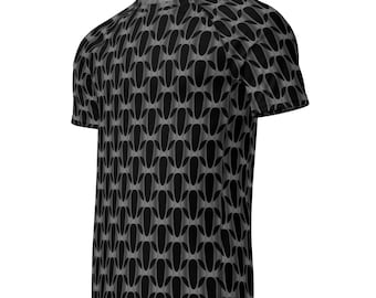 May include: Black and gray patterned t-shirt. The short-sleeved shirt features a repeating geometric design of elongated, oval shapes in varying shades of gray and black. The shirt is made of a soft, lightweight material.