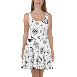 May include: White skater dress with a black all-over print featuring skulls, tarot cards, keys, and other occult symbols. The sleeveless dress has a scoop neckline and a flared skirt, perfect for a casual or themed outfit.