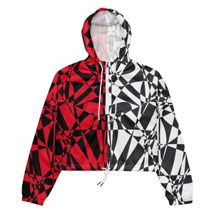 May include: A red and black geometric print hooded jacket with a white zipper and drawstring. The jacket is cropped and has long sleeves.