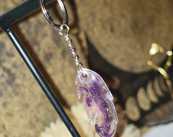 Llavero de resina de plumas brillantes púrpura