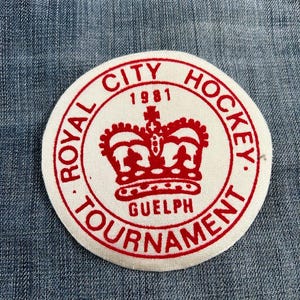 May include: A white circular patch with red text and a red crown. The text reads "Royal City Hockey Tournament 1981 Guelph".