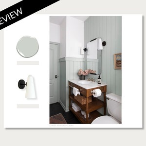 May include: A bathroom with a light green wall, a white sink, and a wooden vanity with a white marble top. The vanity has a basket, towels, and a roll of toilet paper on the shelves. There is a toilet on the right side of the image.