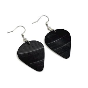 May include: A pair of black guitar pick earrings with silver-colored ear wires. The earrings are shaped like guitar picks and feature the grooves of a vinyl record. The earrings are set against a white background.