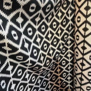 May include: Black and white geometric patterned fabric with a woven texture. The fabric is folded in half, showing the pattern on both sides.