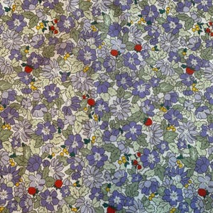 May include: A fabric featuring a dense floral pattern with purple and light lavender flowers, green leaves, small yellow berries, and scattered red strawberries. The design is repetitive and covers the entire surface with a botanical theme.