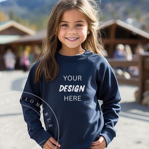 May include: A young person wearing a navy blue sweatshirt with the text "YOUR DESIGN HERE" printed on the front.