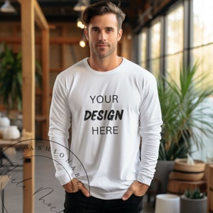 May include: White long-sleeved shirt with the text "YOUR DESIGN HERE" printed on the front.