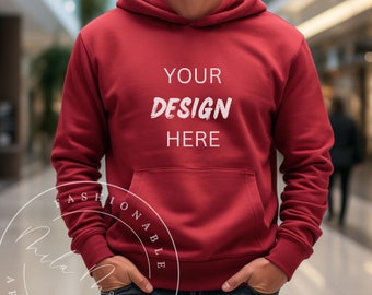 May include: A red hooded sweatshirt with the text "YOUR DESIGN HERE" printed on the front.