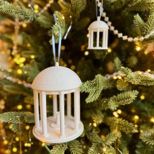 The large and small Old Well ornaments, shown together on a Christmas tree for UNC alumni.