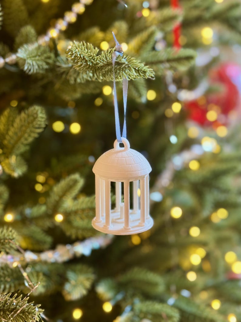 View of the UNC Chapel Hill ornament of the Old Well, shown on a Christmas tree.