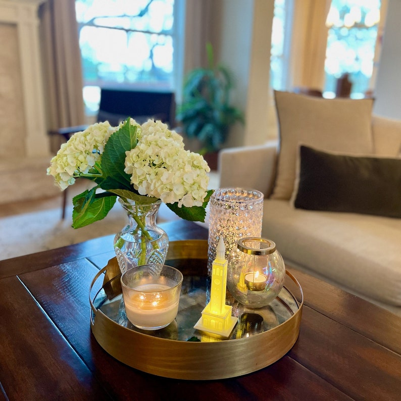 The UNC Tower lighted figurine, shown in a living room setting.