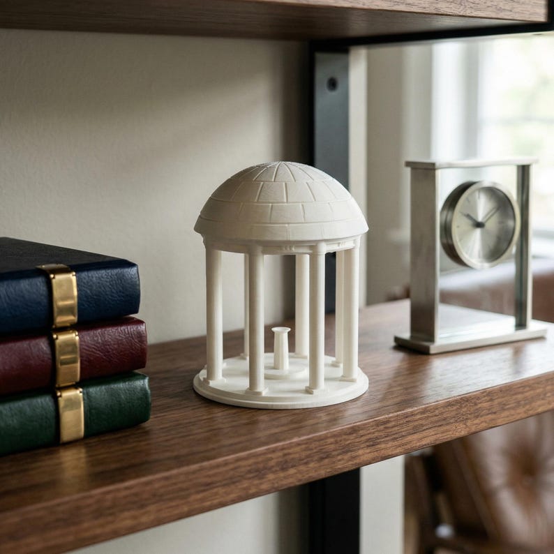 The UNC figurine used as office decor and designed as the Old Well on campus.