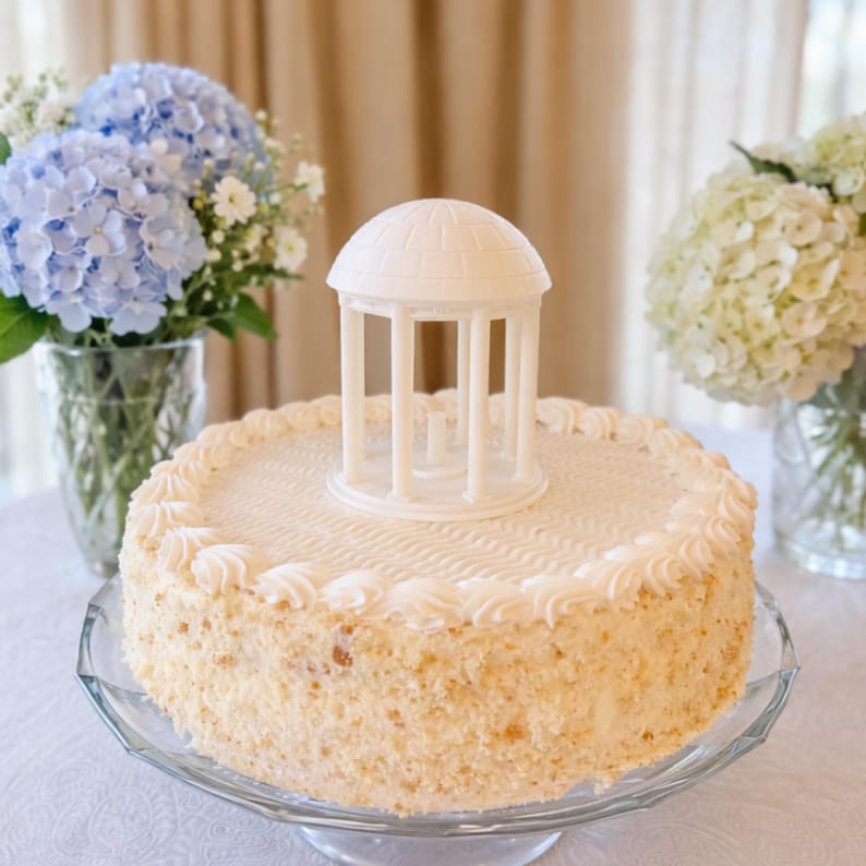The University of North Carolina figurine representing the Old Well, shown on a graduation cake or a groom's cake.