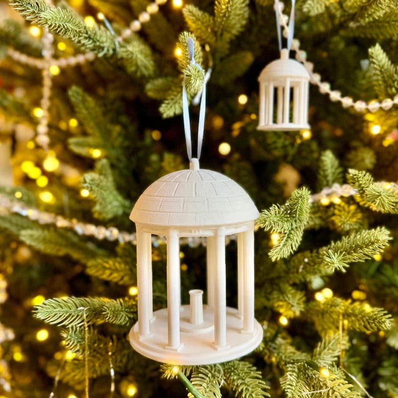 The UNC ornaments designed as the Old Well on campus and shown on the tree of a Tar Heels fan.
