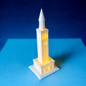 The UNC figurine designed as a replica of the Memorial Bell Tower on the Chapel Hill campus.