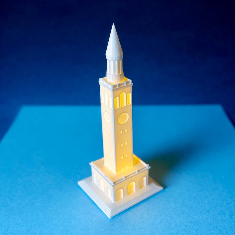 The UNC figurine designed as a replica of the Memorial Bell Tower on the Chapel Hill campus.