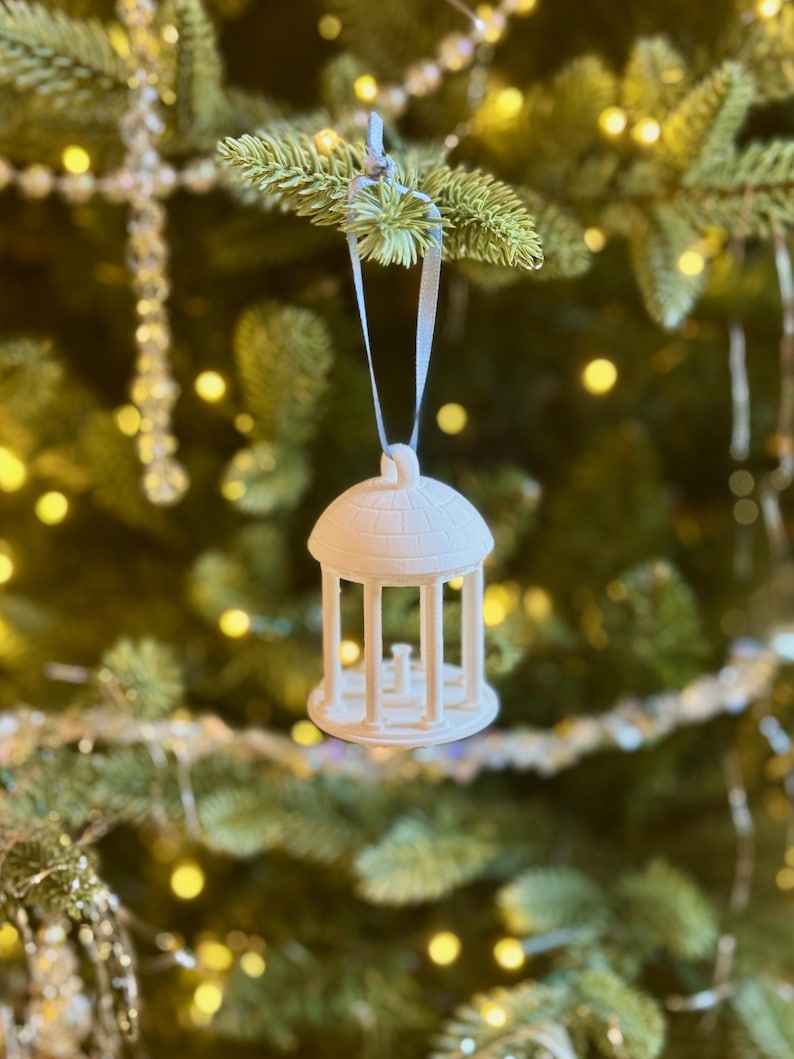 The UNC Old Well ornament shown on a Chapel Hill tree.