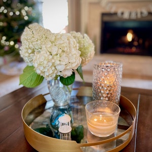The UNC Old Well ornament, styled in a living room for the holidays.