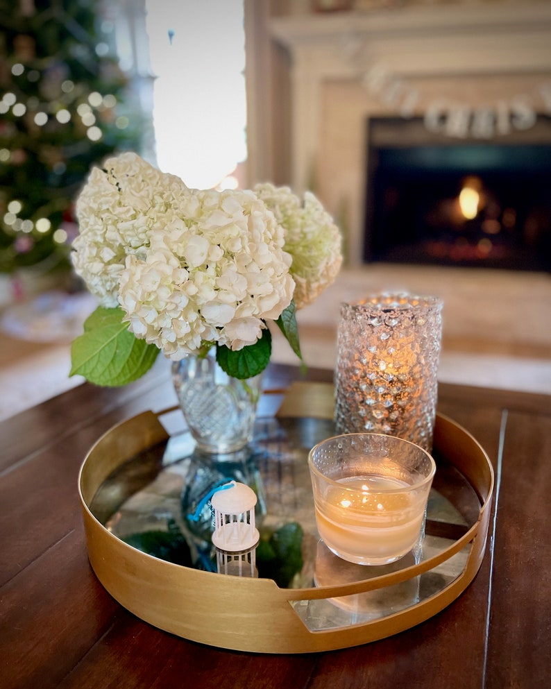 The UNC Old Well ornament, styled in a living room for the holidays.