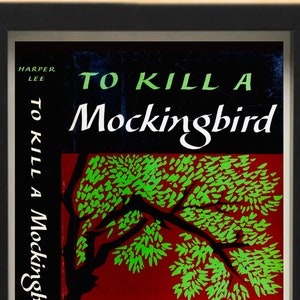 May include: A framed print of the book cover for "To Kill a Mockingbird" by Harper Lee. The cover features a red background with a green tree and the title in white lettering.