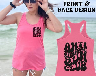 May include: Pink tank top with a black graphic that says "Anti Running Club" in a retro font. The graphic is on the front and back of the tank top.