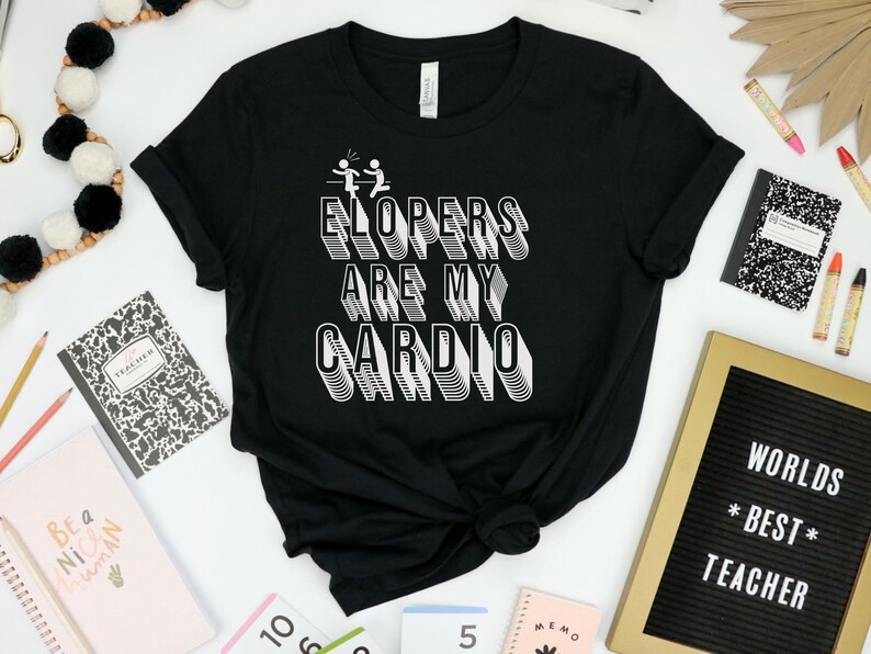May include: Black t-shirt with white text that reads "ELOPERS ARE MY CARDIO" in a 3D style. The text is surrounded by two stick figures running.