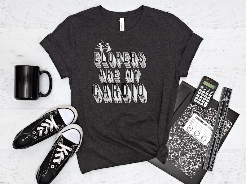 May include: A dark gray t-shirt with white text that reads "ELOPERS ARE MY CARDIO". The text is in a bold, blocky font.