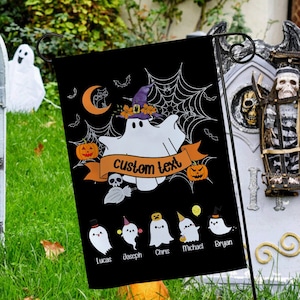 May include: A black Halloween garden flag with a white ghost wearing a witch hat and the text "custom text". The flag has a black spiderweb design and orange pumpkins. Below the ghost are five smaller ghosts with names written below them: Lucas, Joseph, Chris, Michael, and Bryan.