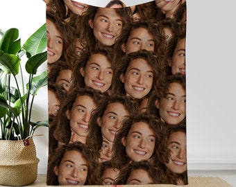 May include: A brown fleece blanket with a repeating pattern of a person's face. The person is smiling and has brown hair.