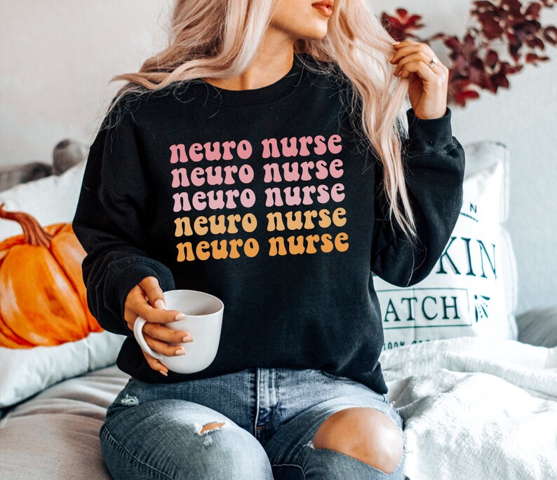 May include: A black sweatshirt with the text "neuro nurse" repeated five times in a pink and orange retro font.