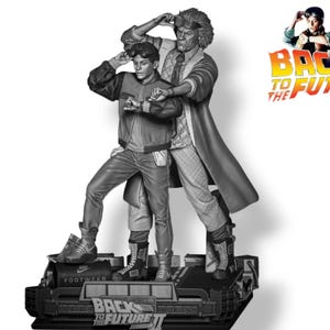 May include: Black and white statue of two figures from the movie Back to the Future. The figures are standing on a base that says "Back to the Future II" and "Footwear".