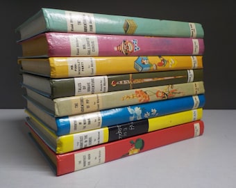 May include: A stack of ten vintage children's books with colorful covers featuring illustrations of a clown, a bird, a flower, and a sword. The books are titled "The Adventures of Pip", "Mr. Pink-Whistle's Party", "Mr. Galliano's Circus", "The Adventures of Four Adventurers", "The Wish of the Wise Chair", "Tales of Brave Adventure", "The Adventures of Pip", "The Naughtiest Girl in the School", "Secret 18 183", and "The Naughtiest Girl in the School".