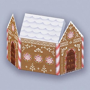 May include: A brown gingerbread house illustration with white icing details, candy cane stripes, and peppermint candies. The roof is white with a snow-like texture. The text "@KITTENSBRUSH" is visible on the side of the house.