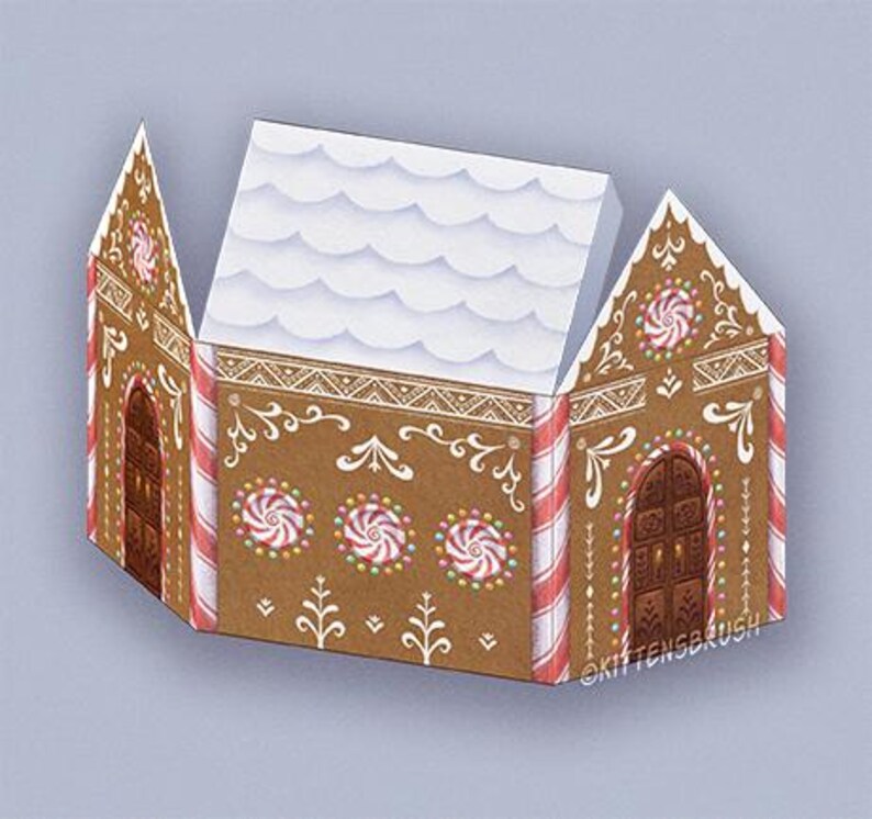 May include: A brown gingerbread house illustration with white icing details, candy cane stripes, and peppermint candies. The roof is white with a snow-like texture. The text "@KITTENSBRUSH" is visible on the side of the house.