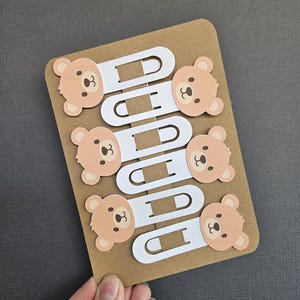 zoomed out view of 6pack of cardstock bear bookmarks blue black background