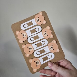 zoomed out full display of brown bear cardstock clip bookmarks clipped onto display pack
