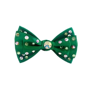May include: A green bow tie with a large clear rhinestone in the centre and smaller rhinestones scattered across the fabric.