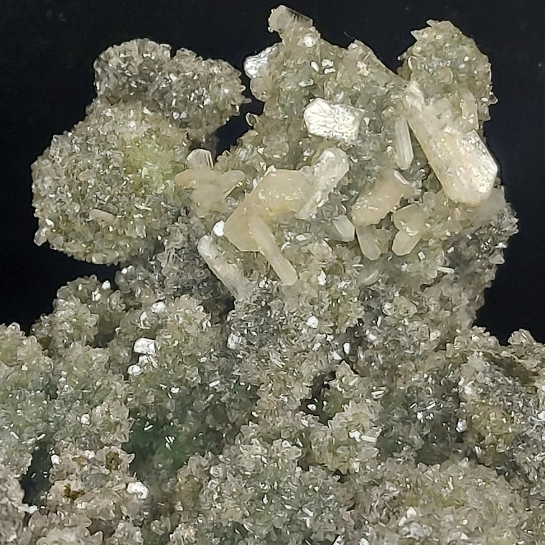 Green chalcedony druzy coated calcite cluster with stilbite crystals on dark background