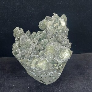 Close up of green chalcedony druzy surface with calcite crystal texture