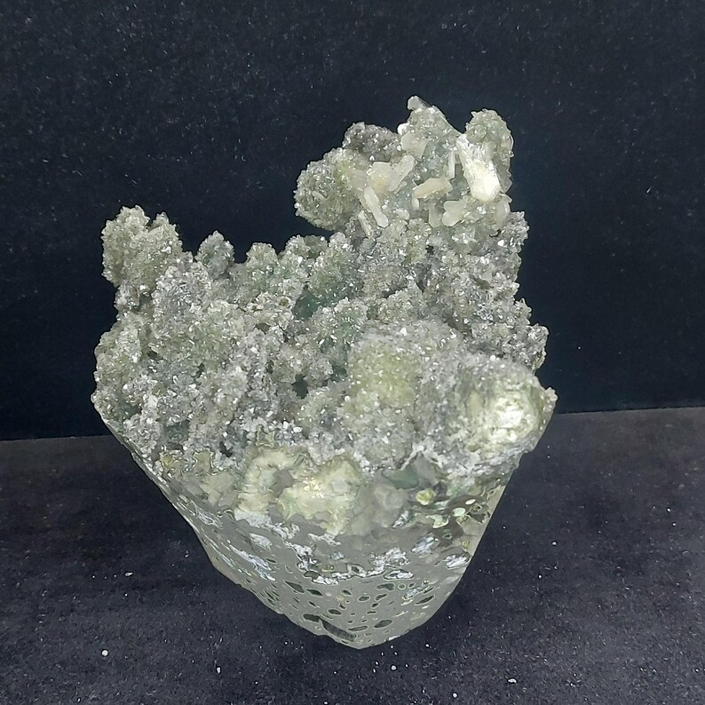 Close up of green chalcedony druzy surface with calcite crystal texture