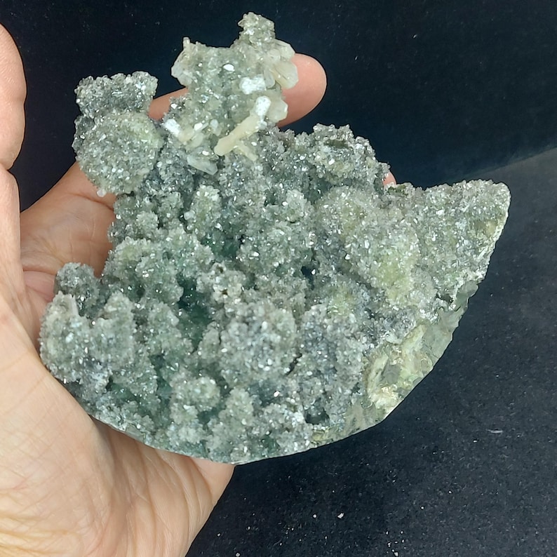 Green chalcedony druzy calcite cluster held in hand for scale