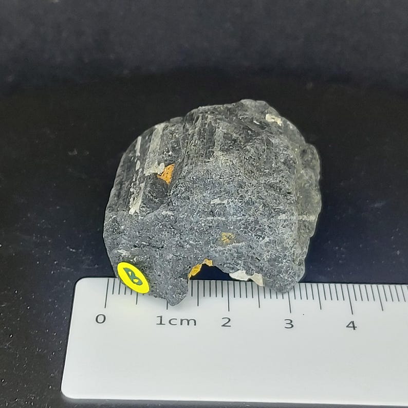 Black tourmaline rough crystal photographed upright showing natural growth pattern