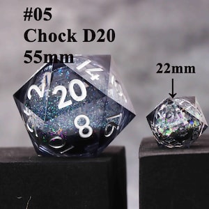 May include: Two polyhedral dice, a D20 measuring 5.5cm and a smaller 2.2cm die. The dice are clear with a dark interior filled with glitter. The larger die has white numbers.