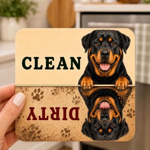 May include: A square dishwasher magnet featuring a Rottweiler dog. The top half is light tan with the word CLEAN in black. The bottom half is textured brown with paw prints and the word DIRTY in dark red, featuring an inverted Rottweiler image.