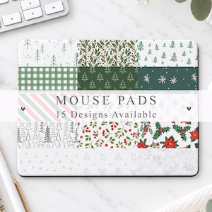 May include: A rectangular mouse pad featuring a grid of fifteen distinct holiday-themed patterns, including evergreen trees, holly berries, poinsettias, snowflakes, and plaid designs. The text MOUSE PADS 15 Designs Available is centred on the surface.
