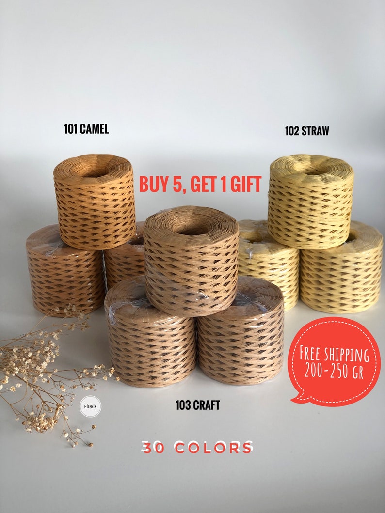 May include: Three spools of paper twine in different colors: camel, straw, and craft. The spools are stacked on top of each other. The text "BUY 5, GET 1 GIFT" is written in red letters above the spools. The text "FREE SHIPPING 200-250 GR" is written in a speech bubble in the lower right corner of the image. The text "30 COLORS" is written in black letters below the spools.