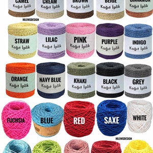 May include: A collection of twenty-five spools and balls of paper yarn in various colors including camel, cream, brown, beige, cinnamon, straw, lilac, pink, purple, indigo, orange, navy blue, khaki, black, grey, fuchsia, blue, red, saxe, white, baby blue, green, rose gold, maroon, and yellow.